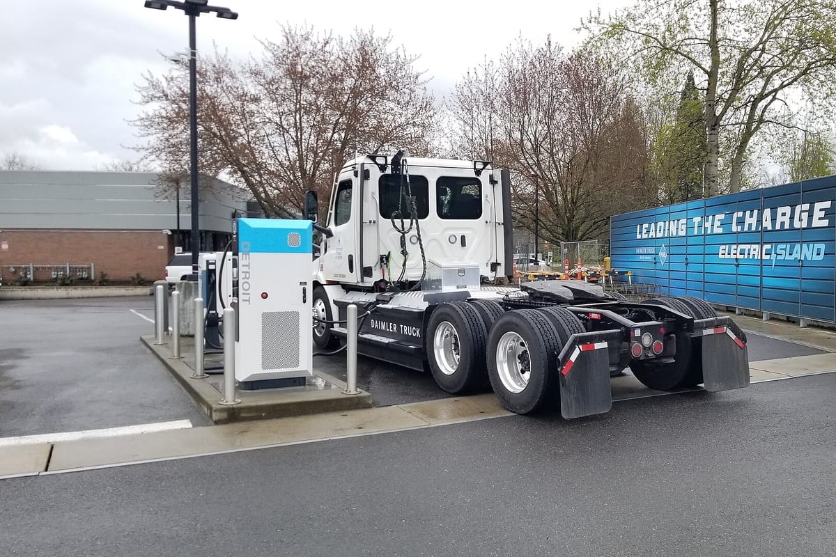A battery-electric heavy-duty truck at a charging station